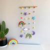 hanging display with colorful rainbows, paired with moon, star and felt balls