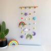 hanging display with colorful rainbows, paired with moon, star and felt balls